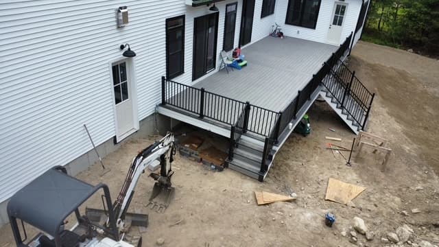 Composite deck mid-construction showing framing and decking installation from aerial perspective