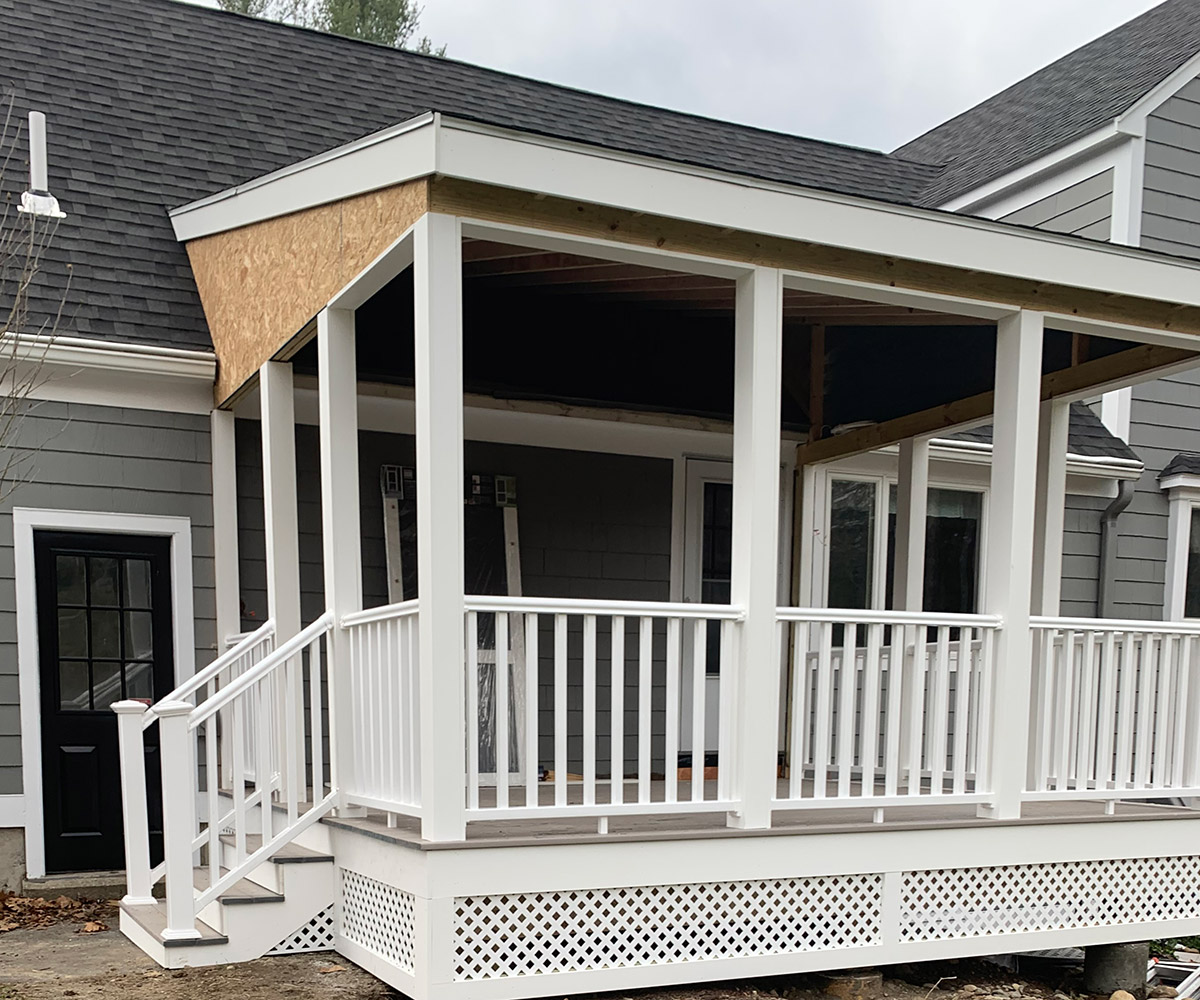 Porch with white railing and steps leading down.